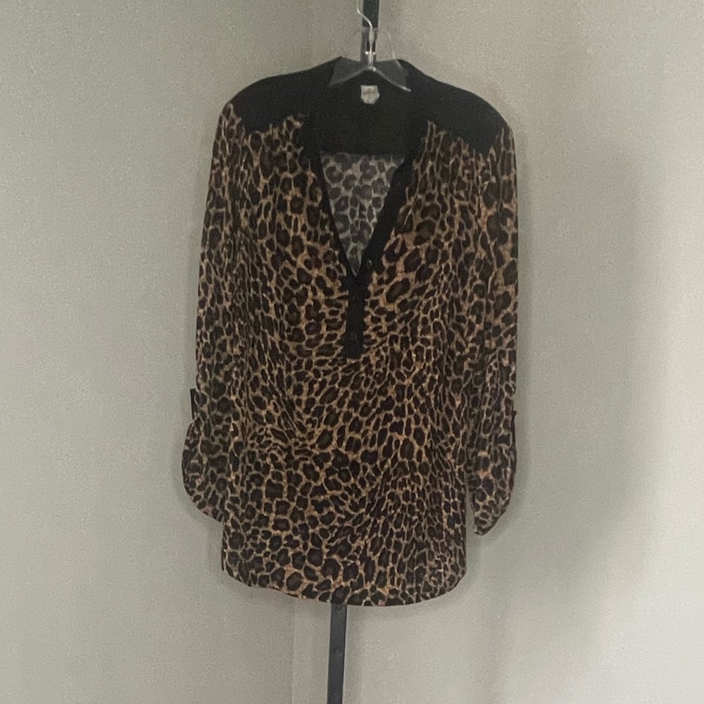 Animal print blouse. Cute button details. Black accent panels.